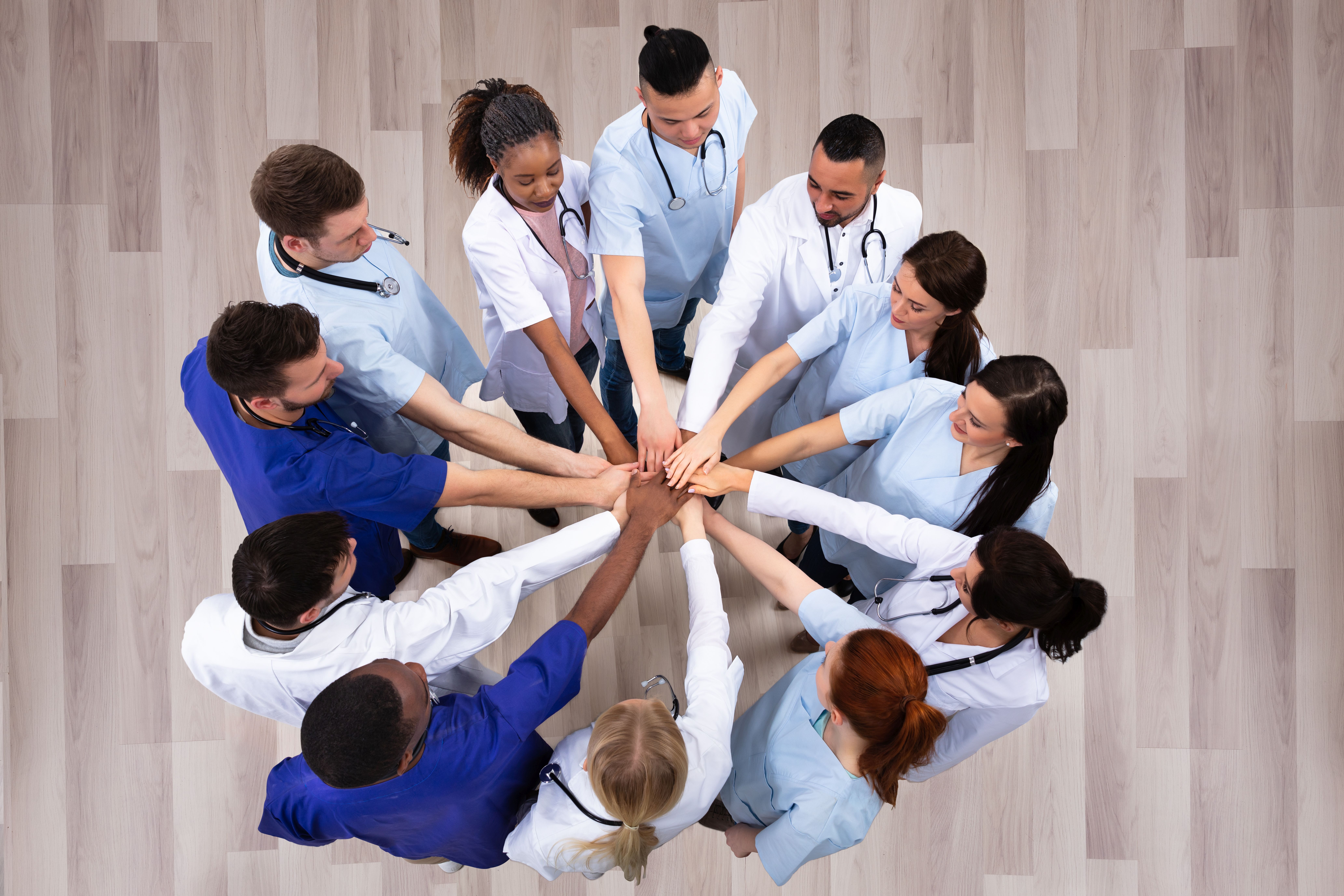 Directly Above Shot Of Medical Team Stacking Hands Together At Hospital